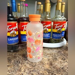 Glass frosted water bottle with mushrooms and pumpkins and moons